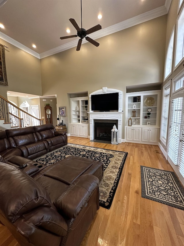 103 Welborn Oaks Way, Anderson, SC 29621 - living area featuring a high ceiling, ceiling fan, a fireplace with flush hearth, plenty of natural light, and stairway