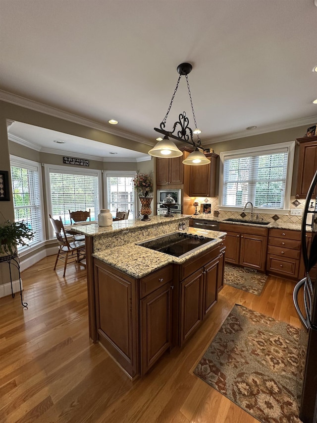 103 Welborn Oaks Way, Anderson, SC 29621 - kitchen with black electric stovetop, plenty of natural light, ornamental molding, and light wood-style floors