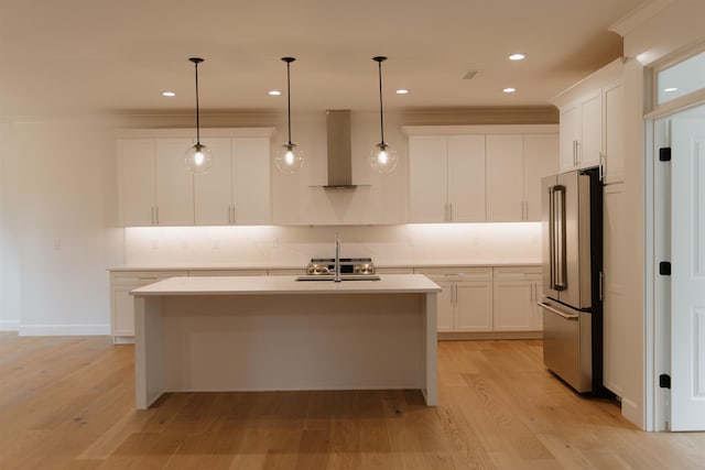 305 Meadow Tree Ct, Travelers Rest, SC 29690 - kitchen with high end refrigerator, wall chimney exhaust hood, decorative backsplash, light countertops, and white cabinetry