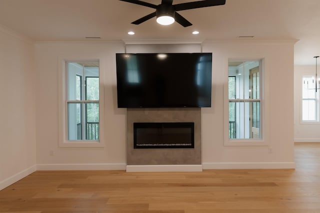 305 Meadow Tree Ct, Travelers Rest, SC 29690 - unfurnished living room featuring a glass covered fireplace, ceiling fan, crown molding, light wood-style floors, and recessed lighting