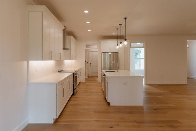305 Meadow Tree Ct, Travelers Rest, SC 29690 - kitchen with stainless steel appliances, recessed lighting, decorative light fixtures, light wood-style flooring, and white cabinets