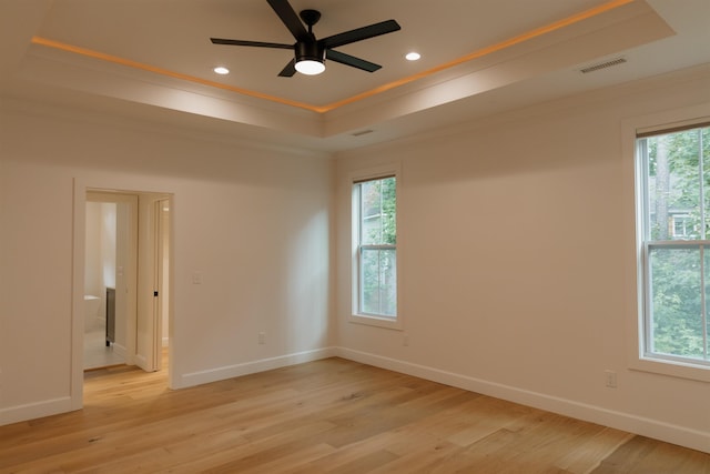 305 Meadow Tree Ct, Travelers Rest, SC 29690 - empty room with a raised ceiling, ornamental molding, light wood-type flooring, recessed lighting, and ceiling fan