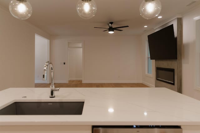 305 Meadow Tree Ct, Travelers Rest, SC 29690 - kitchen featuring light stone counters, open floor plan, ceiling fan, a large fireplace, and light wood-type flooring
