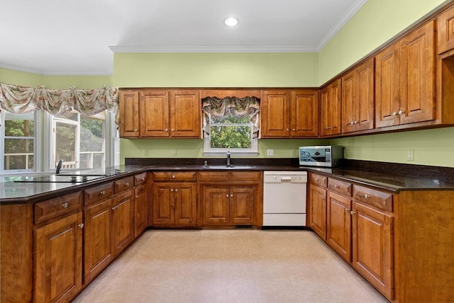 216 Antrim Ave, Moore, SC 29369 - kitchen featuring dishwasher, stainless steel microwave, ornamental molding, brown cabinetry, and dark countertops