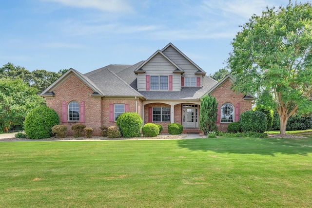 528 Carolee Way, Greer, SC 29651 - view of front of house with a front yard, brick siding, a shingled roof, and a porch