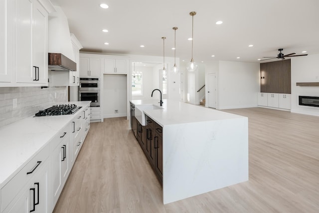 3619 Pennington Rd, Greer, SC 29651 - kitchen with stainless steel appliances, light wood-style floors, recessed lighting, decorative backsplash, and white cabinets