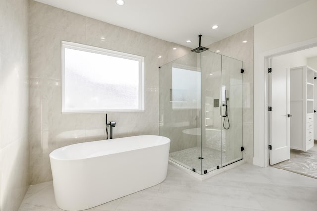 3619 Pennington Rd, Greer, SC 29651 - bathroom with a stall shower, marble look tile flooring, a freestanding bath, tile walls, and recessed lighting