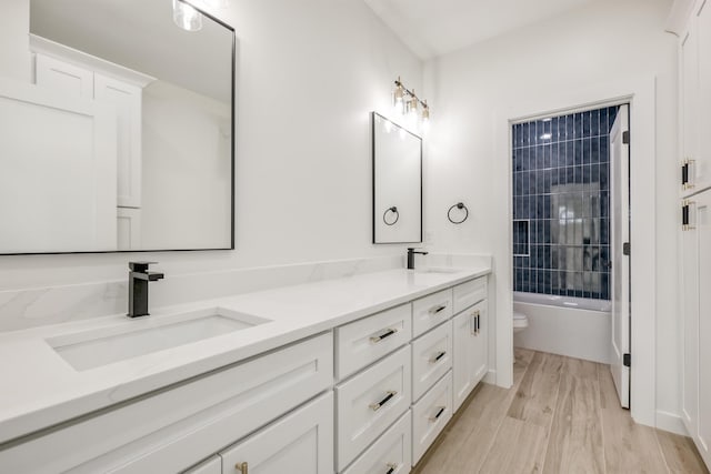 3619 Pennington Rd, Greer, SC 29651 - full bathroom with double vanity, wood finished floors, and bathing tub / shower combination