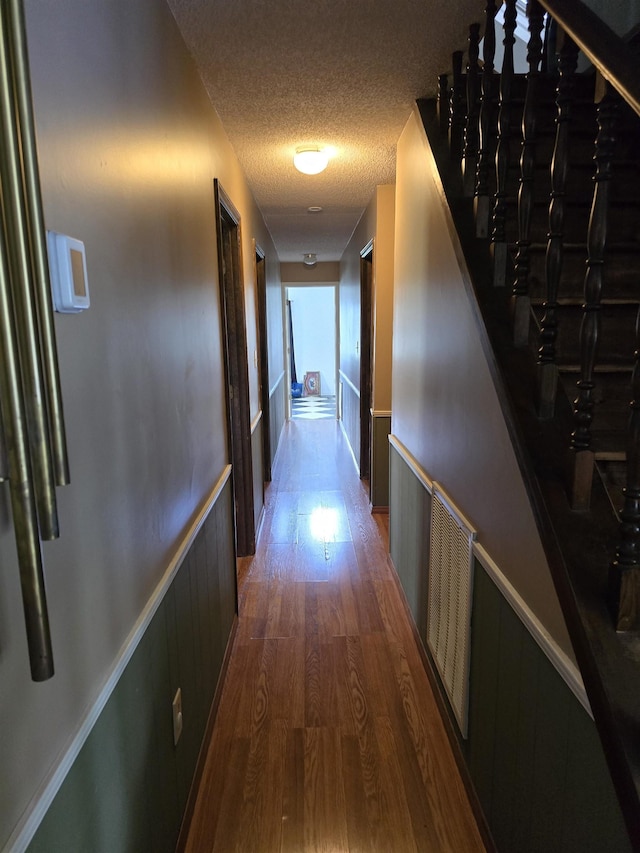 123 Sheraton Loop, Gaffney, SC 29341 - hallway with wainscoting, a textured ceiling, wood finished floors, and stairway
