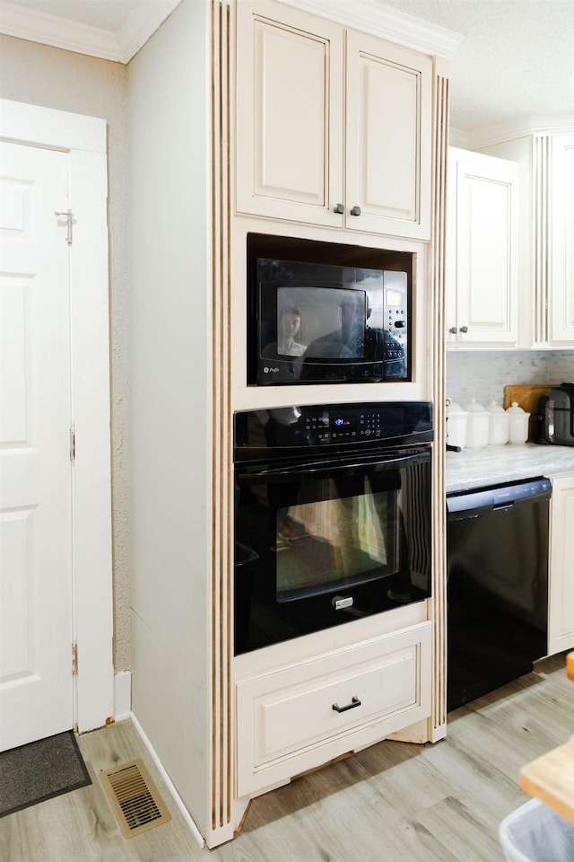 1218 Parker Rd, Enoree, SC 29335 - kitchen featuring black appliances, ornamental molding, light wood-type flooring, white cabinetry, and light countertops