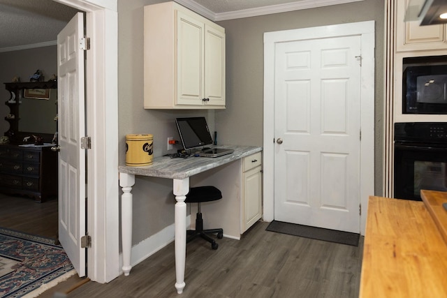 1218 Parker Rd, Enoree, SC 29335 - kitchen with black appliances, ornamental molding, dark wood finished floors, wooden counters, and built in desk