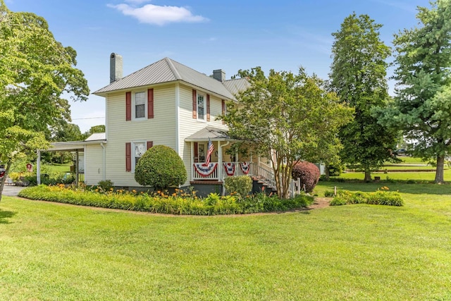 601 Front St, Chesnee, SC 29523 - traditional style home featuring a chimney, covered porch, a front yard, a metal roof, and an attached carport