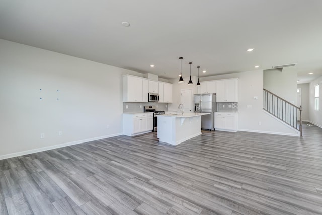 210 Wakelon Dr, Greer, SC 29651 - kitchen with open floor plan, stainless steel appliances, light wood-style flooring, light countertops, and recessed lighting