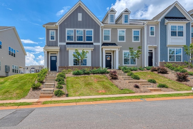 210 Wakelon Dr, Greer, SC 29651 - view of front of home featuring a standing seam roof, board and batten siding, a metal roof, and a front lawn