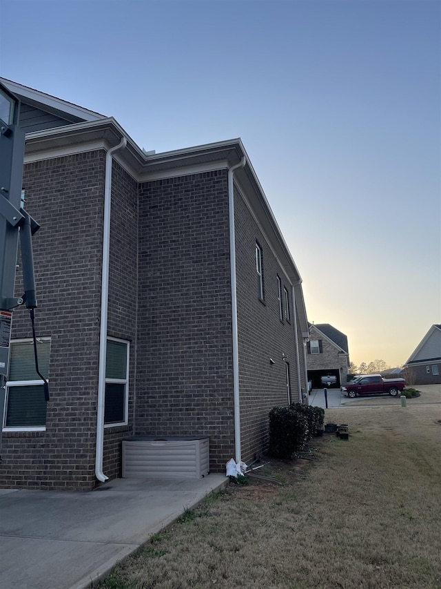 499 Gorham Dr, Boiling Springs, SC 29316 - property exterior at dusk featuring brick siding and a yard