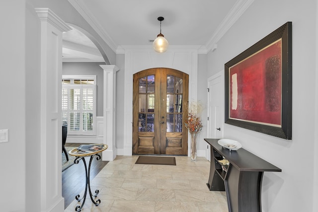 498 Double Bridge Rd, Boiling Springs, SC 29316 - foyer entrance with arched walkways, crown molding, french doors, decorative columns, and stone tile flooring