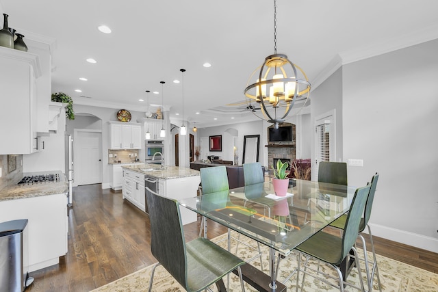 498 Double Bridge Rd, Boiling Springs, SC 29316 - dining space with a chandelier, arched walkways, ornamental molding, recessed lighting, and dark wood finished floors