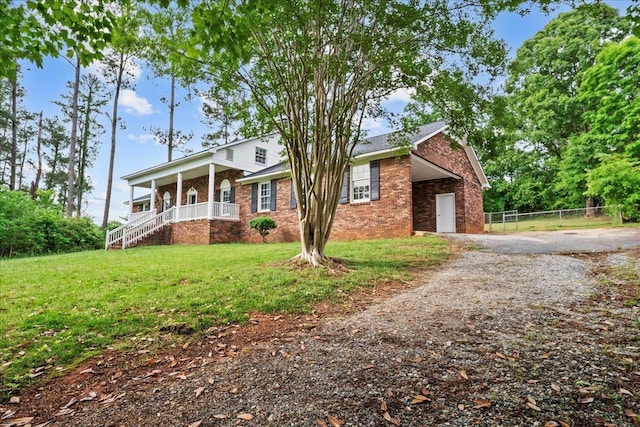 251 Winfield Dr, Spartanburg, SC 29307 - view of front of house with covered porch, brick siding, gravel driveway, and an attached carport