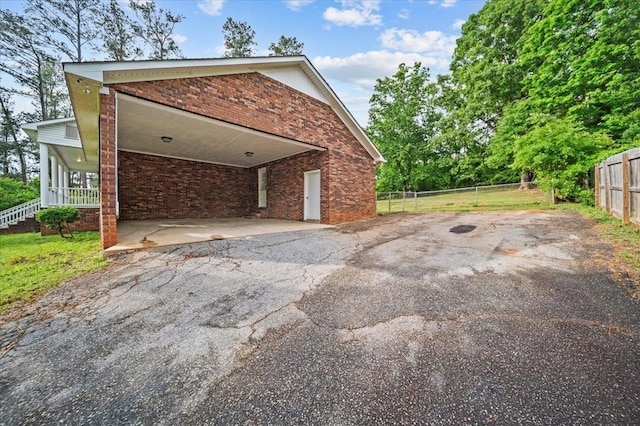 251 Winfield Dr, Spartanburg, SC 29307 - view of side of home featuring asphalt driveway, a carport, and brick siding