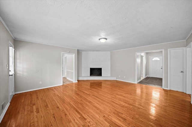 251 Winfield Dr, Spartanburg, SC 29307 - unfurnished living room with a textured ceiling, wood finished floors, ornamental molding, and a fireplace