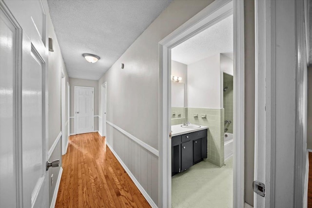 251 Winfield Dr, Spartanburg, SC 29307 - hall featuring a textured ceiling, wainscoting, and light wood-style floors