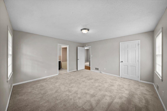 251 Winfield Dr, Spartanburg, SC 29307 - unfurnished bedroom featuring a textured ceiling, carpet floors, and ensuite bathroom