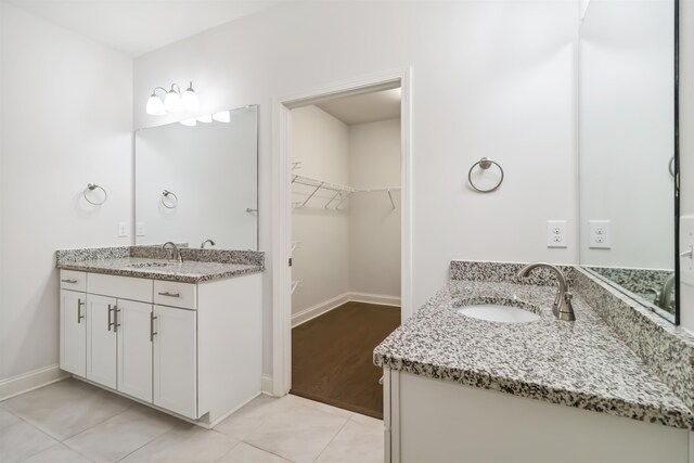 881 Deepwood Ct, Boiling Springs, SC 29316 - bathroom featuring two vanities, a spacious closet, and tile patterned flooring