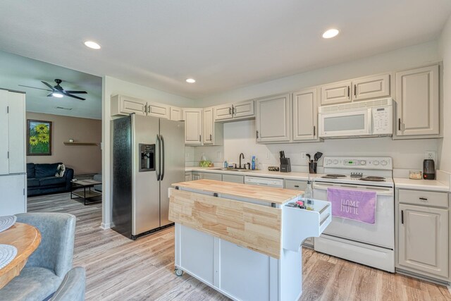 703 Patriot Ln, Greer, SC 29651 - kitchen with white appliances, light wood finished floors, a ceiling fan, a center island, and recessed lighting