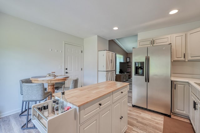 703 Patriot Ln, Greer, SC 29651 - kitchen with stainless steel refrigerator with ice dispenser, wooden counters, recessed lighting, light wood-style floors, and a kitchen island
