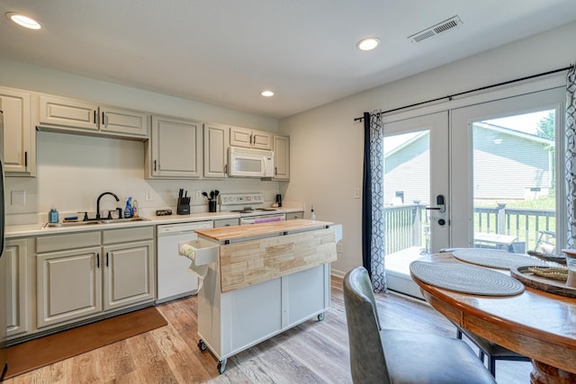 703 Patriot Ln, Greer, SC 29651 - kitchen with white appliances, plenty of natural light, light wood-style floors, recessed lighting, and french doors