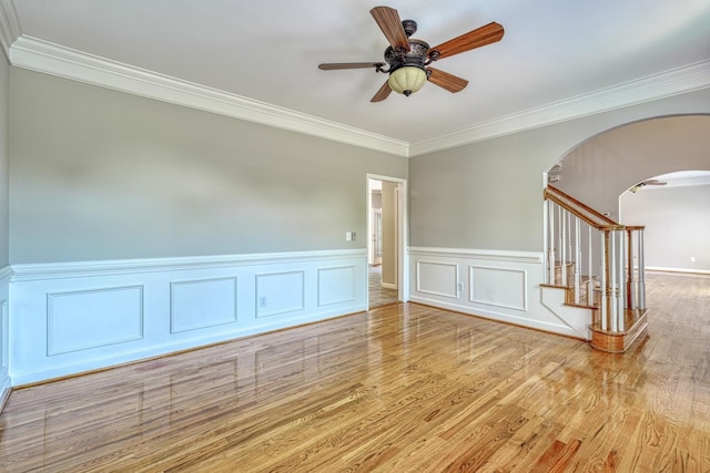 95 Roscommon Run, Moore, SC 29369 - unfurnished room with a ceiling fan, arched walkways, ornamental molding, wood finished floors, and a wainscoted wall