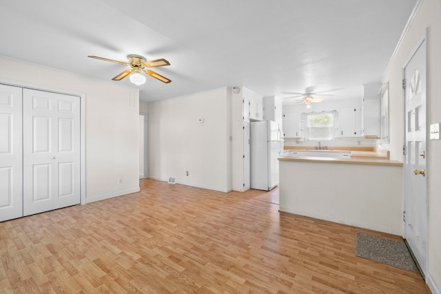 114 W Carolina St, Duncan, SC 29344 - kitchen with ceiling fan, freestanding refrigerator, a peninsula, and light wood-style flooring