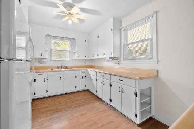 114 W Carolina St, Duncan, SC 29344 - kitchen with freestanding refrigerator, open shelves, light wood-style flooring, ceiling fan, and light countertops
