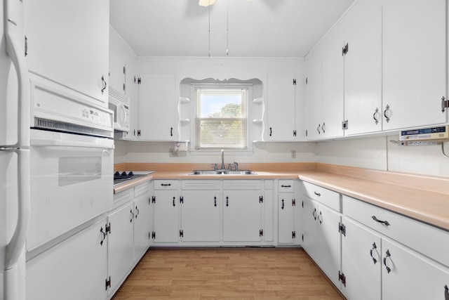 114 W Carolina St, Duncan, SC 29344 - kitchen with white appliances, white cabinets, light wood-style floors, light countertops, and open shelves