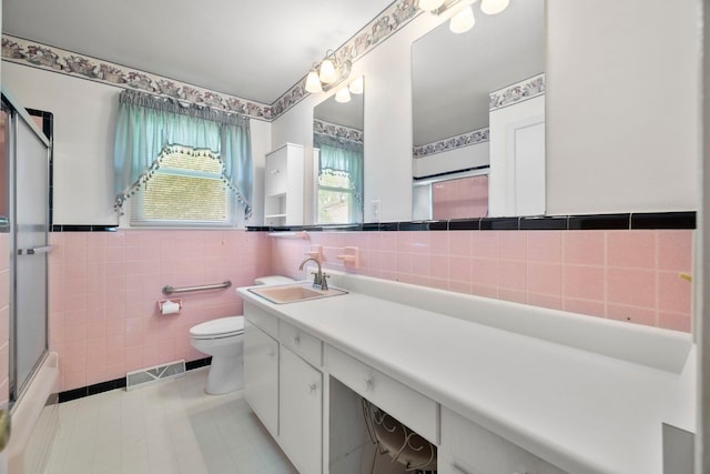 114 W Carolina St, Duncan, SC 29344 - bathroom with tile walls, tile patterned flooring, vanity, and wainscoting