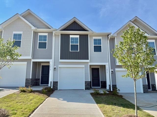 1236 Forestbrook Ln, Spartanburg, SC 29303 - view of front of property with board and batten siding, stone siding, driveway, and a front yard