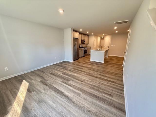 1236 Forestbrook Ln, Spartanburg, SC 29303 - kitchen featuring stainless steel appliances, recessed lighting, wood finished floors, a kitchen island with sink, and open floor plan