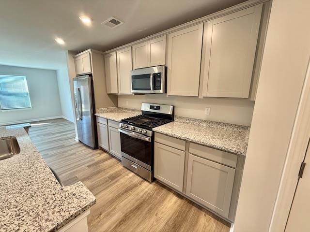 1236 Forestbrook Ln, Spartanburg, SC 29303 - kitchen featuring appliances with stainless steel finishes, light wood-style flooring, recessed lighting, and light stone countertops