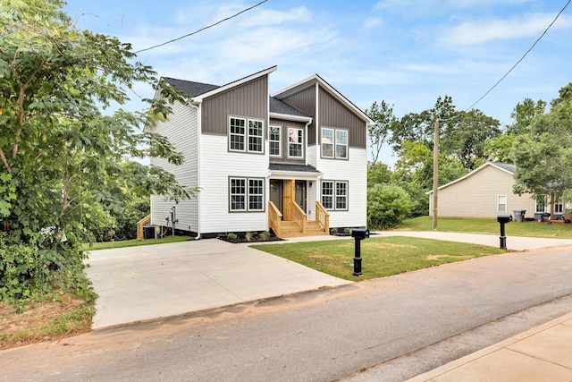 938 Logan St, Spartanburg, SC 29306 - view of front facade with a front lawn and board and batten siding