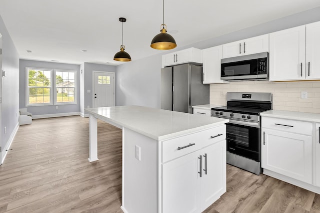 938 Logan St, Spartanburg, SC 29306 - kitchen with appliances with stainless steel finishes, light countertops, light wood finished floors, and tasteful backsplash