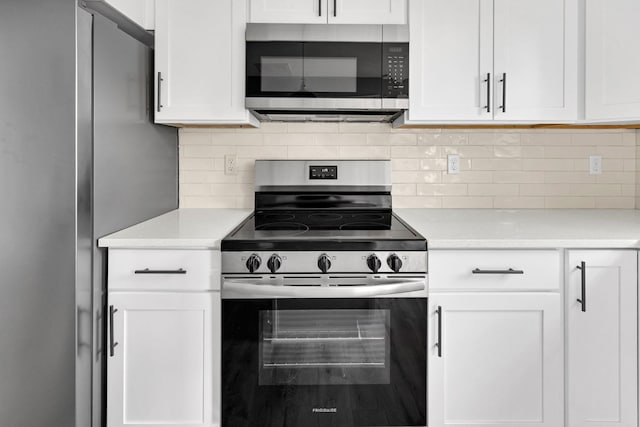 938 Logan St, Spartanburg, SC 29306 - kitchen featuring stainless steel appliances, light countertops, white cabinets, and tasteful backsplash