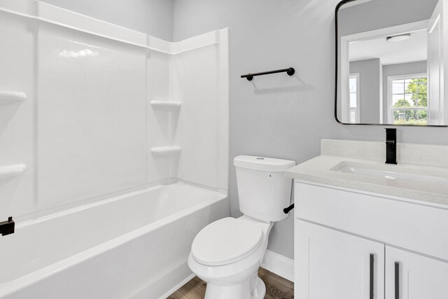 938 Logan St, Spartanburg, SC 29306 - full bath with vanity, wood finished floors, and tub / shower combination