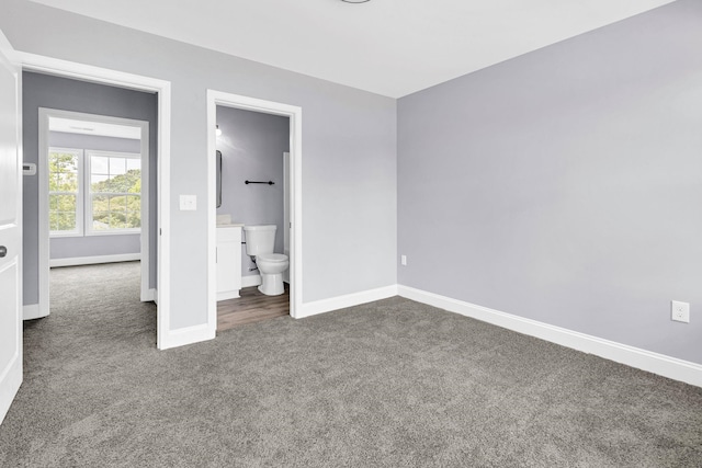 938 Logan St, Spartanburg, SC 29306 - unfurnished bedroom featuring dark colored carpet and connected bathroom