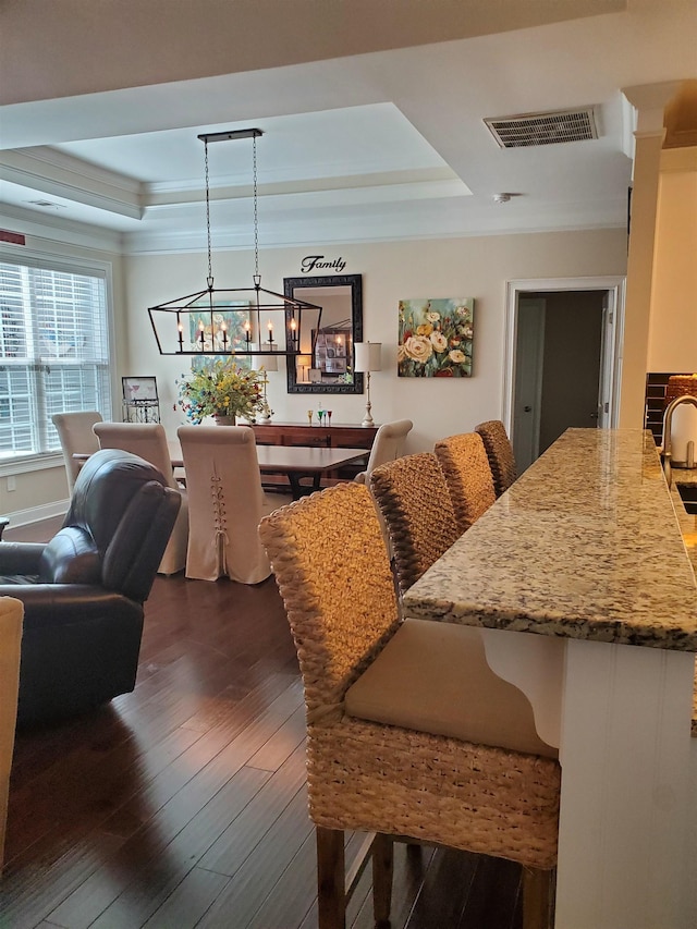 178 Ravines Ln, Spartanburg, SC 29301 - dining space featuring a raised ceiling, dark wood-type flooring, a chandelier, and crown molding