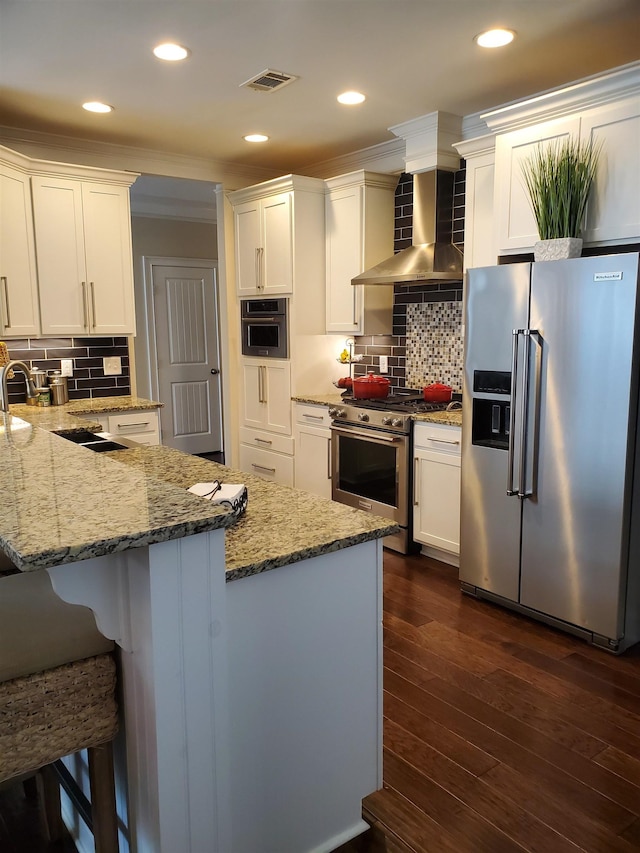 178 Ravines Ln, Spartanburg, SC 29301 - kitchen featuring stainless steel appliances, wall chimney exhaust hood, white cabinets, recessed lighting, and crown molding