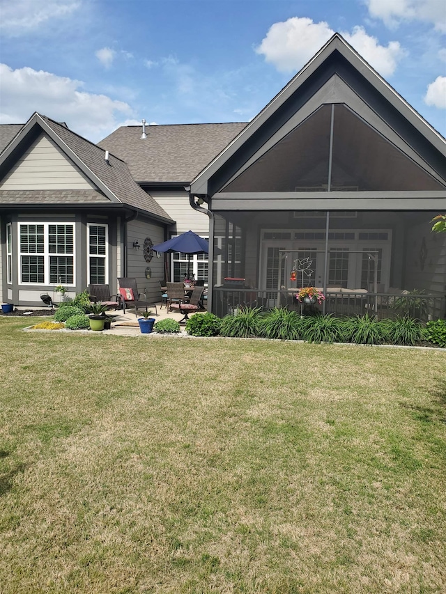 178 Ravines Ln, Spartanburg, SC 29301 - back of property featuring a lawn, a patio, a sunroom, and roof with shingles