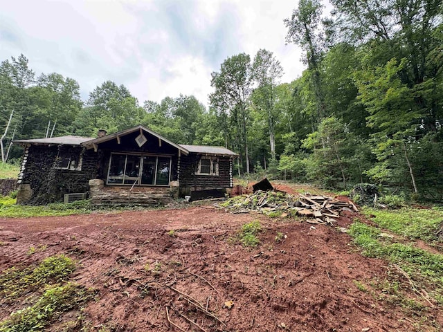 8875 N Tigerville Rd, Travelers Rest, SC 29690 - view of front of home with a chimney, log siding, and a wooded view