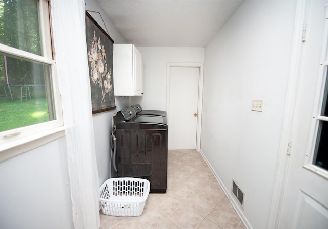 72 Casey Ln, Spartanburg, SC 29301 - washroom featuring washer and dryer, cabinet space, light tile patterned floors, and a textured ceiling