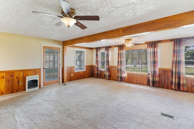 1620 Rainbow Lake Rd, Inman, SC 29349 - unfurnished living room featuring heating unit, a wainscoted wall, a textured ceiling, wood walls, and ceiling fan