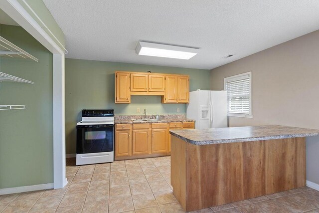 1620 Rainbow Lake Rd, Inman, SC 29349 - kitchen featuring white appliances, light tile patterned flooring, a textured ceiling, and a peninsula